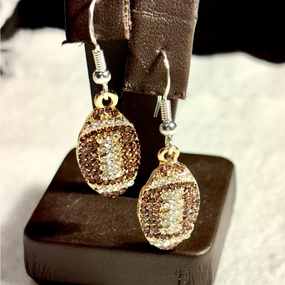 Earrings made by Corinne’s artistic creations .  Rhinestone footballs with 925